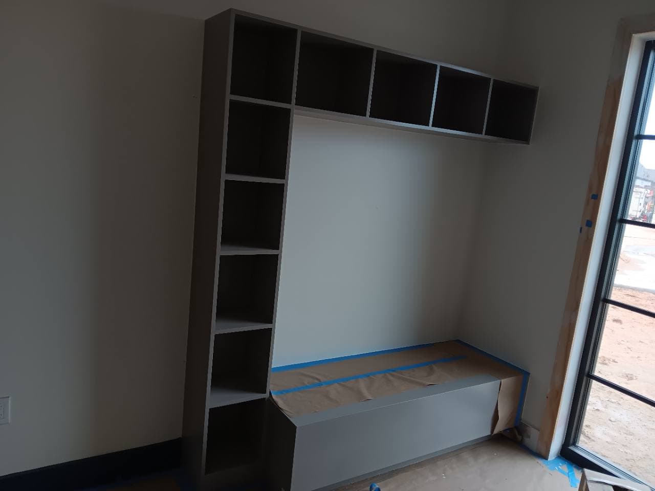 Built-in common-area shelving during finishing and drying stage.